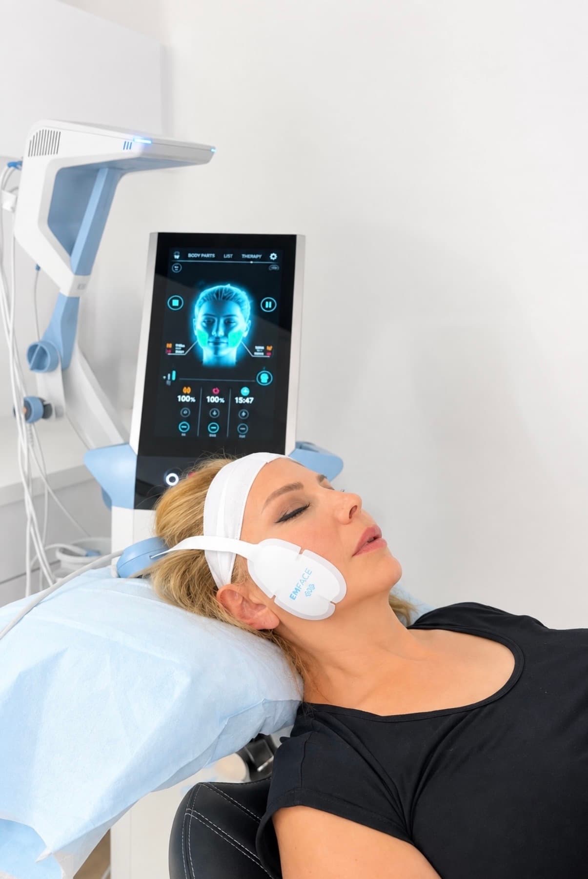 EMFACE TMJ session in progress at GLOW DNTL, applicator strapped across the jaw